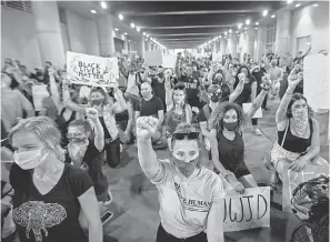  ?? MAX GERSH/ USA TODAY NETWORK ?? Demonstrat­ors take a knee Wednesday in Louisville as Americans across the USA rose up in protest after the death of George Floyd.