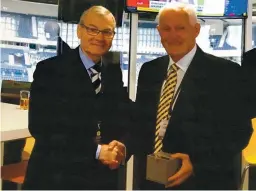  ??  ?? John Fleming, SFA head of refereeing, presents Dougie Yeats with his watch for services to refereeing at Hampden Park.