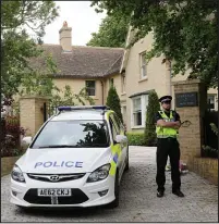  ??  ?? Police guard: The family’s six-bedroom house