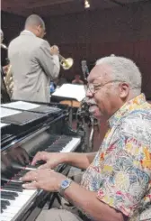  ?? MARY ALTAFFER/AP ?? Ellis Marsalis plays the piano while his son Wynton tries his trumpet during a sound check in 2003 at Lincoln Center in New York.