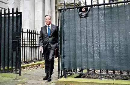  ?? ?? Britain’s new Foreign Secretary David Cameron arrives to attend a cabinet meeting in London on Tuesday. Cameron’s associatio­n with the ex-MEP Nirj Deva raises further questions about his own past involvemen­t with Chinese investment projects (Pic by Ben Stansall/AFP)