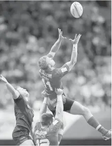  ??  ?? Canada’s Harry Jones is lifted by Adam Zaruba to grab the ball away from Scotland’s Mark Robertson.