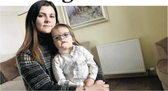  ?? Photograph: Sandy McCook ?? COLD COMFORT: Lisa Ross, with daughter Layla, 2, has paid out extra on gas cards due to inefficien­t heating.