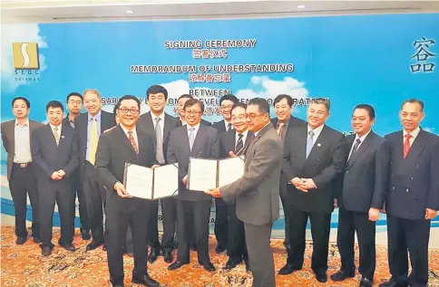  ??  ?? Abang Johari (eighth right) witnessing the exchange of MoU documents between SEDC and Beijing Glory as (from right) Penguang, Aziz Hussain, Morshidi and Wong (sixth right) look on.