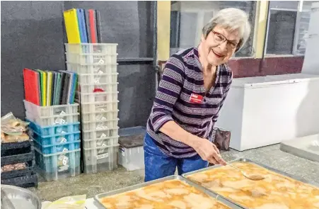  ??  ?? Elaine prepares breakfast for medical mission workers with Helps Internatio­nal.