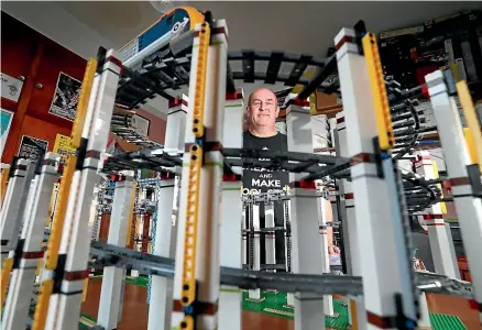  ?? ROBYN EDIE/STUFF ?? Gavin Evans is attempting to build the world’s tallest Lego train tower at his home in Roslyn Bush, near Invercargi­ll.