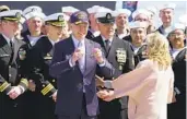  ?? CAROLYN KASTER AP ?? President Joe Biden visits with Navy personnel after a commission­ing ceremony for the submarine Delaware.