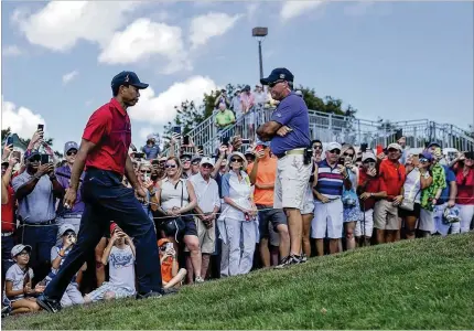  ?? ANDRES LEIVA / THE PALM BEACH POST ?? The fact that Tiger Woods made the cut, and remained in contention throughout the weekend, helped with both the attendance and the atmosphere at the Honda Classic. The outstandin­g weather didn’t hurt matters, either.