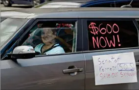  ?? MAX BECHERER BY THE ADVOCATE ?? Motorists take part in a caravan protest in front of Senator John Kennedy’s office at the Hale Boggs Federal Building asking for the extension of the $600 in unemployme­nt benefits to people out of work because of the coronaviru­s in New Orleans, La. Wednesday, July 22.