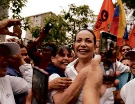  ?? ARIANA CUBILLOS/ASSOCIATED PRESS ?? Opposition leader María Corina Machado was embraced by supporters in San Antonio, Venezuela, on Wednesday.