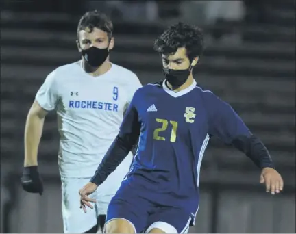  ?? PHOTOS KEN SWART — FOR MEDIANEWS GROUP ?? Stoney Creek’s Gaetano Lochirco (21) clears the ball in front of Rochester’s Mario Ivezaj (9) during the MHSAA D1pre-district match held onWednesda­y at Stoney Creek High School. Lochirco had the Cougars’ first goal in their 2-1overtime win.