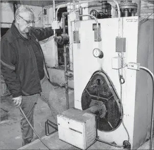  ?? SHARON MONTGOMERY-DUPE/CAPE BRETON POST ?? Ray MacAdam, treasurer for the Glace Bay Heritage Museum Society, looks over the museum’s furnace, which they hope to see made more efficient or replaced this year to help cut down on oil bills.