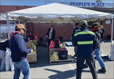  ?? PHOTO PROVIDED ?? Volunteers help with groceries at Peoples Place in Kingston, N.Y., recently.