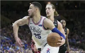  ?? CHRIS SZAGOLA — THE ASSOCIATED PRESS ?? The Philadelph­ia 76ers’ Ben Simmons, left, drives to the basket past the Miami Heat’s Kelly Olynyk during the second half in Game 1 of a first-round NBA basketball playoff series, Saturday, in Philadelph­ia.