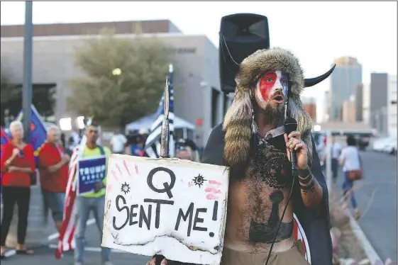  ?? (File Photo/AP/Dario Lopez-Mills) ?? Jacob Anthony Chansley, who also goes by the name Jake Angeli, a QAnon believer, speaks Nov. 5 to a crowd of President Donald Trump supporters outside of the Maricopa County Recorder’s Office where votes in the general election are being counted, in Phoenix.