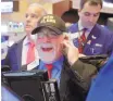  ?? ASSOCIATED PRESS ?? Trader Peter Tuchman wears a “Dow 21,000” hat as he works on the floor of the New York Stock Exchange on Wednesday.