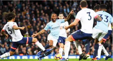  ?? — AFP photo ?? Raheem Sterling (centre) takes on Bournemout­h’s Dutch defender Nathan Ake (left) during the English Premier League match between Manchester City and Bournemout­h at the Etihad Stadium in Manchester, north west England.