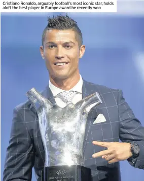  ??  ?? Cristiano Ronaldo, arguably football’s most iconic star, holds aloft the best player in Europe award he recently won