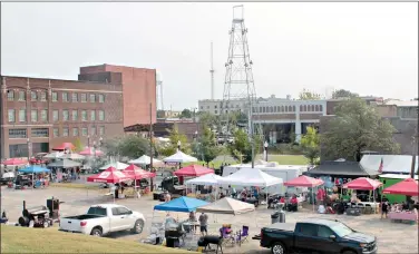  ??  ?? Competitor­s in the Withrow Family Rib Cook off set up at Washington Avenue on Saturday during the SouthArk Foundation’s Outdoor Expo. (Caitlan Butler/News-Times)