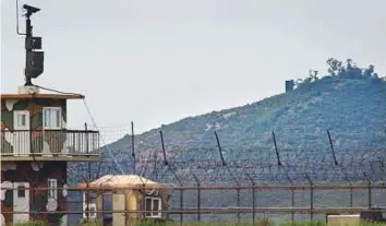  ?? AFP ?? A North Korean propaganda speaker (top right) seen across the Demilitari­sed Zone (DMZ) separating the two countries from the South Korean island of Ganghwa.