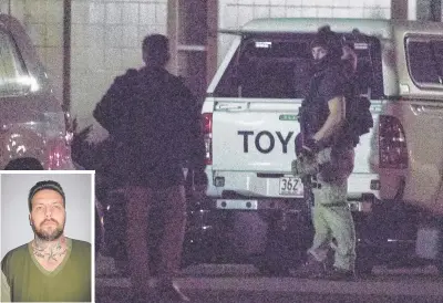  ?? Picture: LACHIE MILLARD ?? Heavily armed police at the scene at Alexandra Headland last night where fugitive Zlatko Sikorsky (inset) was holed up in an apartment building.