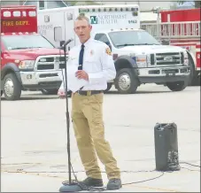  ?? Westside Eagle Observer/SUSAN HOLLAND ?? Gravette fire chief David Orr welcomes guests to the Gravette Fire Department’s second Sept. 11 remembranc­e ceremony Friday morning in the parking lot at CV’s Family Foods. Orr recounted a short history of the Sept. 11, 2001, terrorist attacks and hosted the ceremony which featured Gravette firemen and police officers.