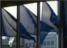  ?? VIRGINIA MAYO — THE ASSOCIATED PRESS ?? Smoke rises from a chimney behind EU flags fluttering in the wind outside EU headquarte­rs in Brussels, Thursday, Dec. 24, 2020.