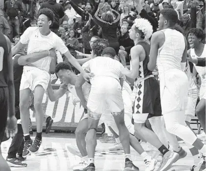  ?? STEVE RUARK/FOR THE BALTIMORE SUN ?? St. Frances's Kyrie Staten, left, and Adrian Baldwin, second from left, celebrate after beating winning the Catholic League b title.