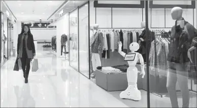  ?? The Associated Press ?? Instead of a Wal-Mart greeter, in the future, shoppers may have a robot greeter. Pepper the robot from SoftBank Robotics can greet shoppers and help steer them to the products they’re looking for.