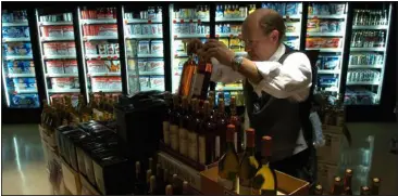  ?? HELEN H. RICHARDSON — THE DENVER POST ?? Robert Arrington stocks wine at a Littleton Safeway, the grocer’s lone Colorado store that can sell liquor. The Associated Press has called the race for Propositio­n 125, with voters approving wine sales in Colorado grocery stores beginning March 1.