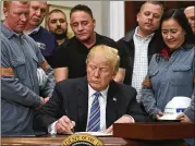  ?? SUSAN WALSH / AP ?? President Donald Trump signs a proclamati­on on steel imports in the Roosevelt Room of the White House, Thursday. He also signed one for aluminum. New tariffs on both will take effect in 15 days.