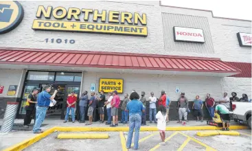  ?? Karen Warren / Houston Chronicle ?? Customers lined up much of the day Friday to buy supplies at Northern Tool + Equipment in Stafford.