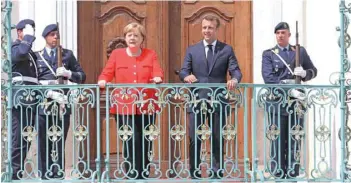  ?? — AFP ?? German Chancellor Angela Merkel and French President Emmanuel Macron look on at the Meseberg Palace in Meseberg, northeaste­rn Germany, on Tuesday.