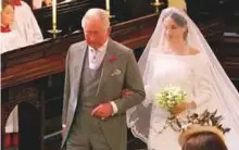  ?? AP ?? Markle walks down the aisle with Prince Charles for her wedding ceremony.