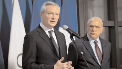  ?? -AFP ?? Bruno Le Maire, the French finance minister, (left) with Ángel Gurria, the secretary general of the OECD.