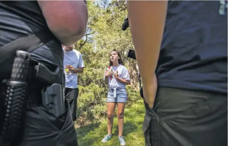  ?? PHOTOS BY JUAN ANTONIO LABRECHE/FOR THE NEW MEXICAN ?? Jade Lopez, 13, of Albuquerqu­e speaks to gun-rights activists, some of whom were armed, Wednesday at Roosevelt Park in Albuquerqu­e. Local students joined survivors of the Parkland, Fla., school shooting at the event, part of the March For Our Lives: Road to Change tour that began in Chicago and is scheduled to make 500 stops in 20 states.