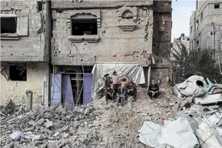  ?? — AFP ?? Waiting and waiting: Palestinia­ns sitting amid debris following overnight Israeli bombardmen­t in rafah, in the southern Gaza Strip, amid the ongoing conflict between Israel and hamas.