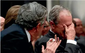  ?? AP ?? Former President George W. Bush, right, cries after speaking during the State Funeral for his father, former President George H.W. Bush, at the National Cathedral in Washington.