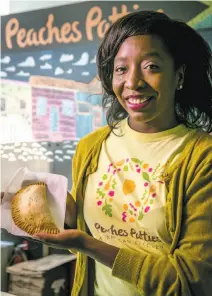  ?? Photos by John Storey / Special to The Chronicle ?? Shani Jones of Peaches Patties holds one of her chicken curry patties at her outpost on Cortland Avenue in S.F.