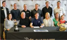  ?? / Jennie Coker ?? Calhoun’s Drew Rutledge signed to play football at Georgia Southern University on Wednesday. Those present at the signing included (front row, from left): sister Tiffany Rutledge, father Mike Rutledge, Drew Rutledge, mother Alisha Rutledge, sister CJ Brown. (Back row, from left): principal Peter Coombe, track and field coach Brant Murry, head coach Hal Lamb, assistant coach Terry Morrow, assistant coach Clay Stephenson, assistant coach Tommie Hoblitzell.