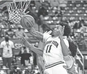  ?? JUSTIN REX/AP ?? Texas Tech’s Kyler Edwards reaches for a rebound during the Red Raiders’ victory over Texas on Saturday in Lubbock, Texas.