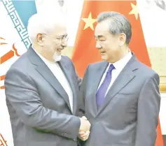  ?? — AFP photo ?? File photo shows Chinese State Councillor and Foreign Minister Wang Yi (right) meeting Iran’s Foreign Minister Mohammad Javad Zarif at the Diaoyutai state guesthouse in Beijing.