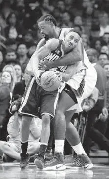  ?? Jae C. Hong Associated Press ?? THE CLIPPERS’ DeAndre Jordan gets a tight hold on the Pacers’ Jeff Teague during the first half of Sunday night’s game.