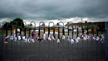  ??  ?? REMEMBRANC­E: Baby shoes hung along a playground fence near the Tuam mother and baby home