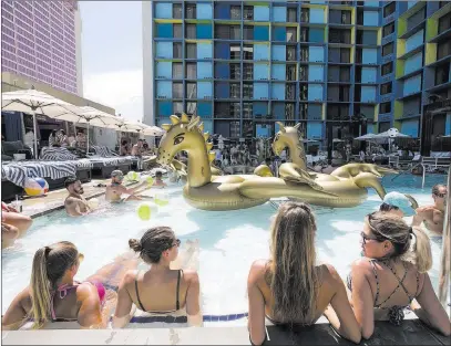  ?? Richard Brian ?? Las Vegas Review-journal @vegasphoto­graph Guests relax poolside Sunday as they listen to the sounds of DJ Kristian Nairn, best known for his role as Hodor in “Game of Thrones,” at The Linq Hotel.