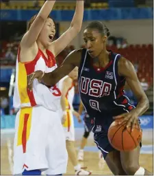  ?? MICHAEL CONROY — THE ASSOCIATED PRESS ?? Lisa Leslie, right, of the United States drives past China’s Wang Ling in the first half a 100-62 win over China in a preliminar­y round game at the Helliniko Indoor Arena in Athens during the 2004 Olympics Games, Aug. 22, 2004.