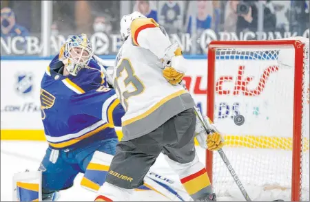  ?? Jeff Roberson The Associated Press ?? Golden Knights defenseman Alec Martinez scores past Blues goaltender Jordan Binnington in the third period Friday at Enterprise Center.