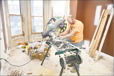  ?? Peter Hvizdak / Hearst Connecticu­t Media ?? Carpenter Scott Fee, an employee of Window Master Real Wood Products of North Haven, cuts wood during the restoratio­n 1389 Chapel St., New Haven, the future home of the Sickle Cell Disease Associatio­n of Southern Connecticu­t.