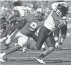  ?? JOSHUA A. BICKEL/COLUMBUS DISPATCH ?? Ohio State defensive end Zach Harrison pressures Maryland quarterbac­k Taulia Tagovailoa.