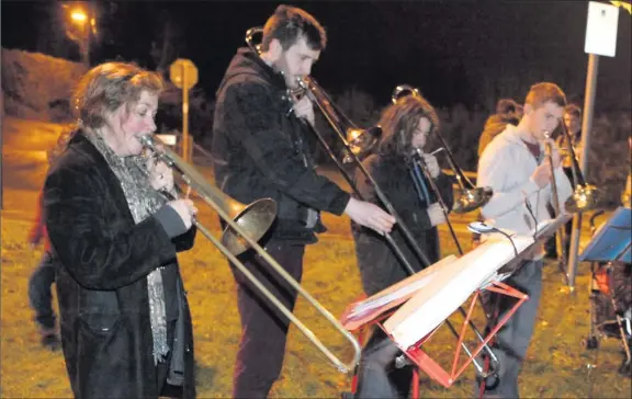  ??  ?? Clare Stephens leads the trombone players at the Kilmac Christmas Carols on the Green.